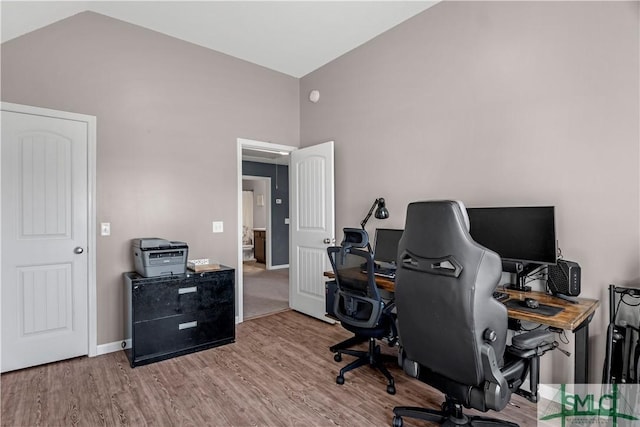 home office with lofted ceiling, wood finished floors, and baseboards