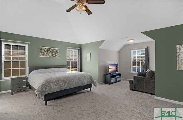 carpeted bedroom with baseboards, ceiling fan, and vaulted ceiling