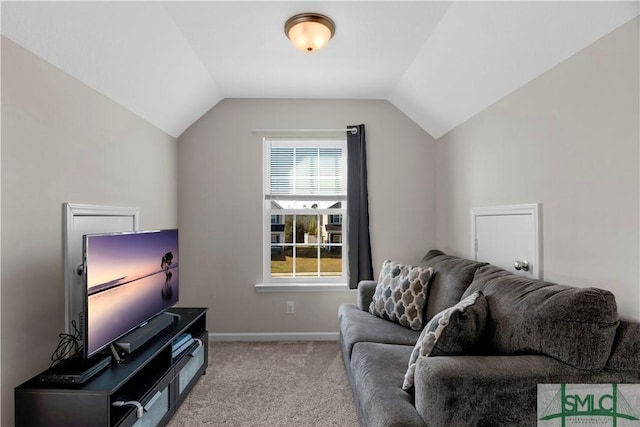 living room featuring lofted ceiling, light colored carpet, and baseboards