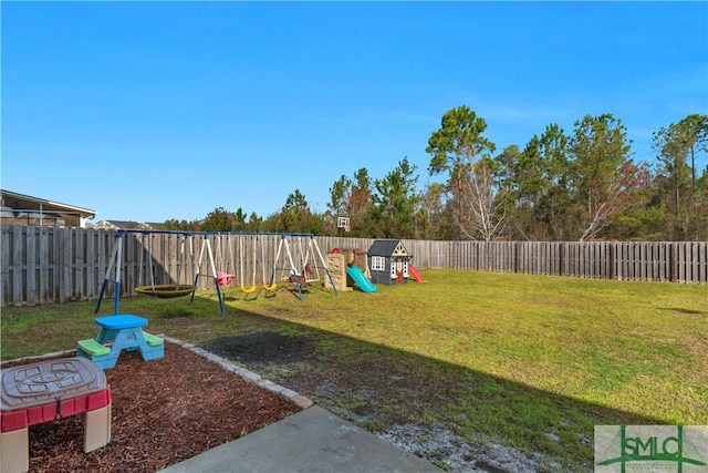 view of yard featuring a playground and a fenced backyard