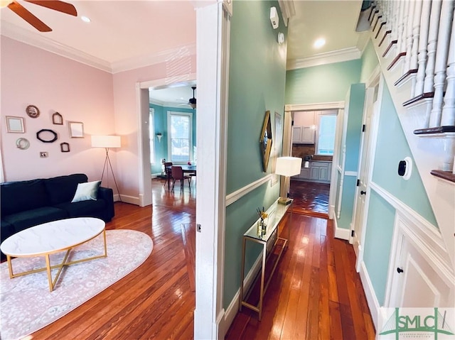 corridor with recessed lighting, baseboards, wood-type flooring, and ornamental molding