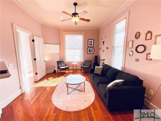 living room with a wealth of natural light, light wood-style floors, and crown molding