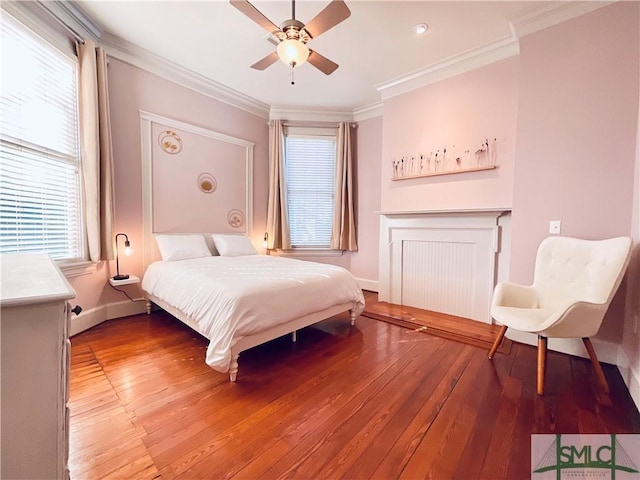 bedroom with light wood-type flooring, baseboards, ornamental molding, and a ceiling fan