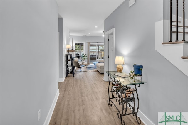 hall with recessed lighting, wood finished floors, and baseboards