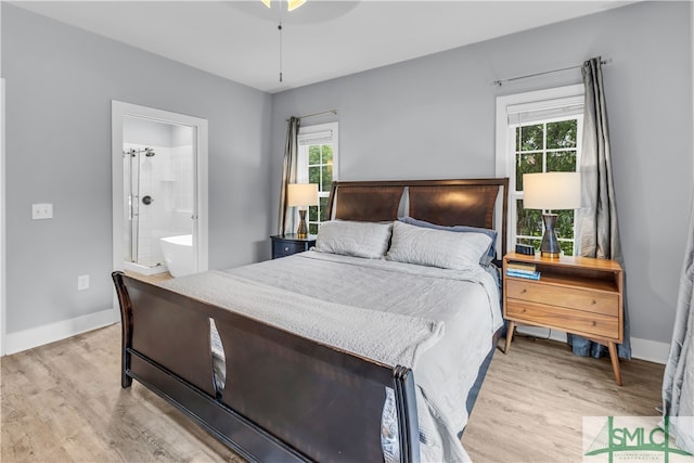 bedroom with ceiling fan, baseboards, ensuite bathroom, and light wood-style floors