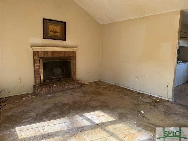 unfurnished living room with vaulted ceiling and a fireplace