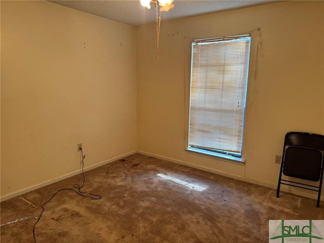 empty room featuring baseboards and carpet floors