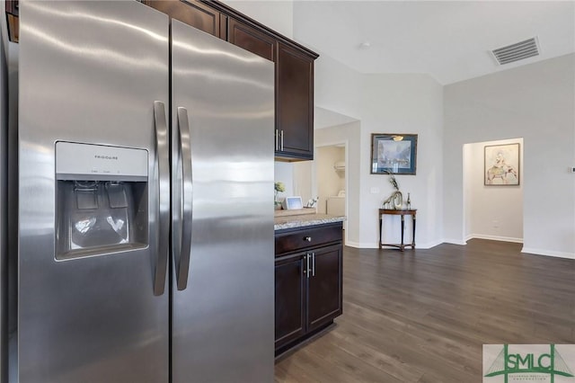 kitchen featuring dark wood-style floors, visible vents, baseboards, stainless steel fridge with ice dispenser, and dark brown cabinetry