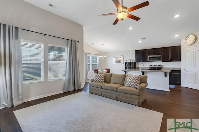 living room with dark wood-type flooring, baseboards, lofted ceiling, recessed lighting, and ceiling fan with notable chandelier