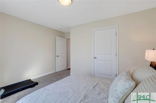 bedroom featuring baseboards and carpet floors