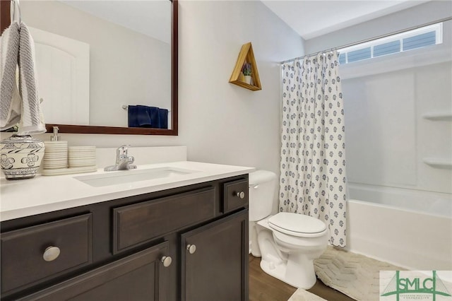 full bathroom featuring vanity, toilet, wood finished floors, and shower / bath combo with shower curtain