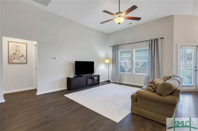 living area with dark wood-style floors, visible vents, baseboards, and a ceiling fan