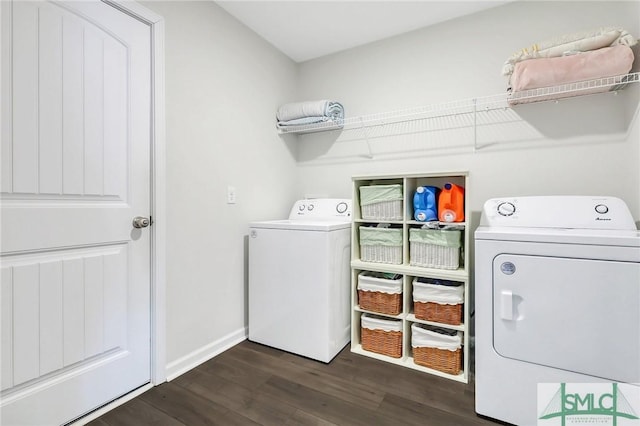 clothes washing area with dark wood-style floors, baseboards, washing machine and dryer, and laundry area