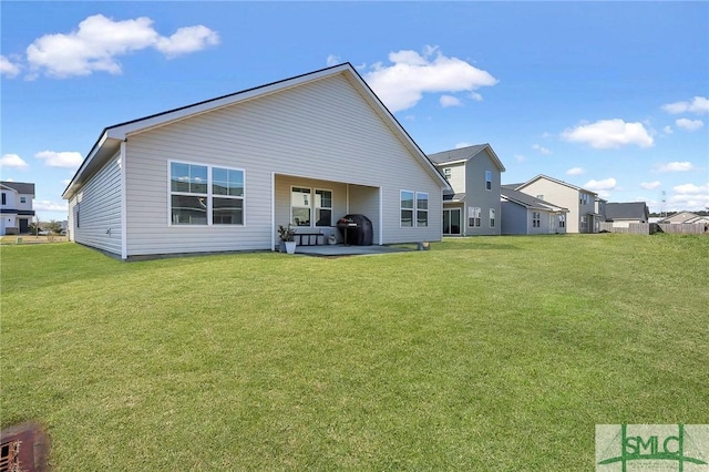 back of house featuring a patio and a lawn