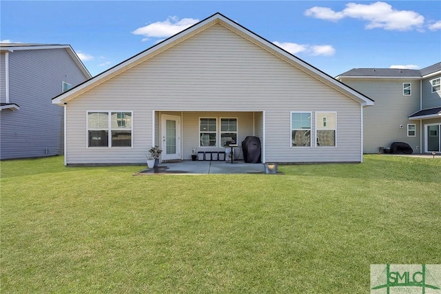 rear view of property featuring a yard and a patio area