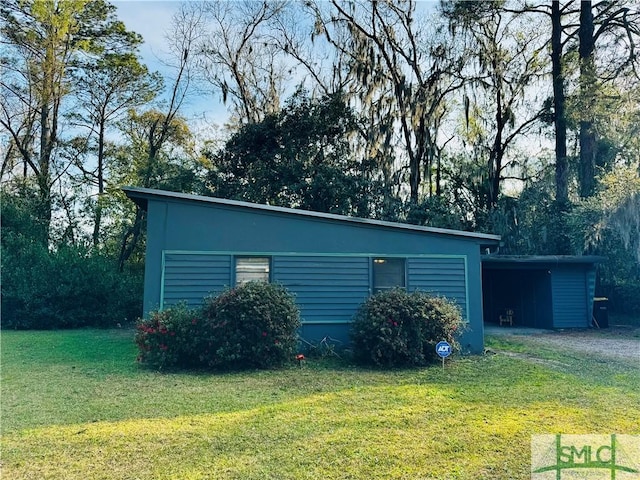 exterior space featuring an attached carport and a yard