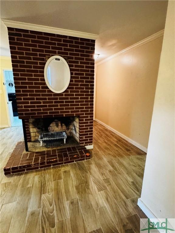 details with a fireplace, crown molding, wood finished floors, and baseboards