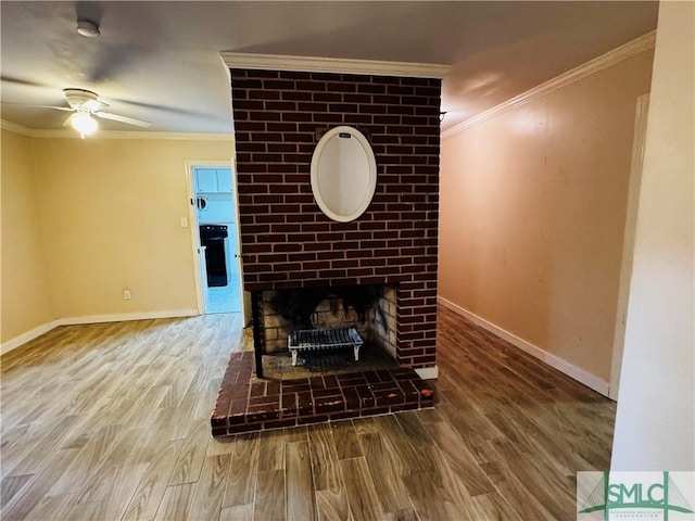 unfurnished living room with a ceiling fan, crown molding, wood finished floors, and baseboards