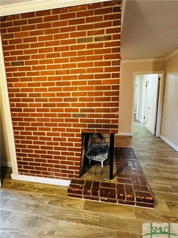 interior details with crown molding, wood finished floors, and baseboards