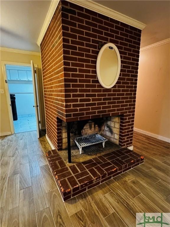 details with wood finished floors, a brick fireplace, and ornamental molding