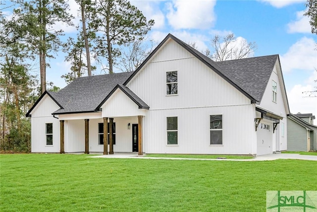 modern farmhouse style home with a garage, driveway, a front lawn, and roof with shingles