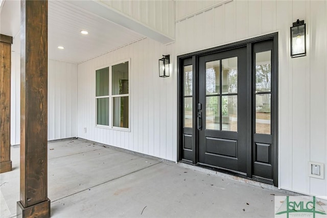 view of exterior entry with a patio