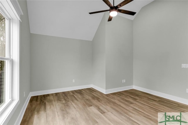 additional living space with wood finished floors, a ceiling fan, baseboards, and vaulted ceiling