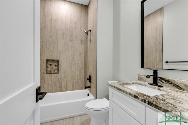 full bathroom featuring vanity, wood finished floors, toilet, and bathtub / shower combination