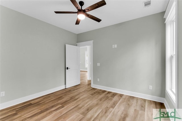 empty room with visible vents, baseboards, ceiling fan, and light wood-style flooring