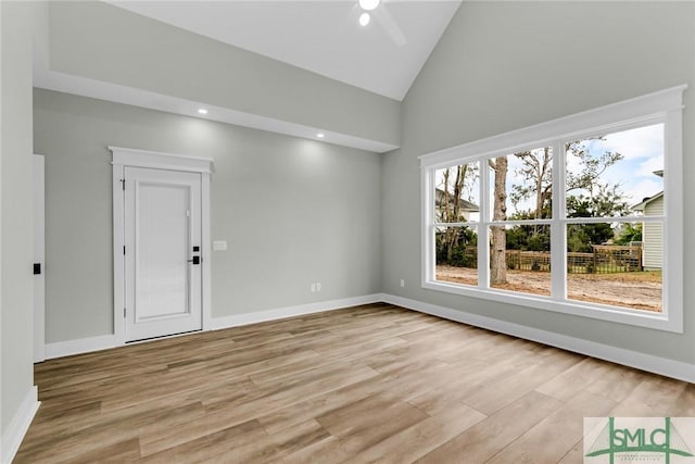 spare room featuring ceiling fan, baseboards, light wood-type flooring, recessed lighting, and high vaulted ceiling