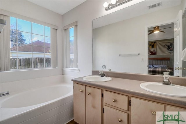 bathroom featuring visible vents, a sink, connected bathroom, and a bath