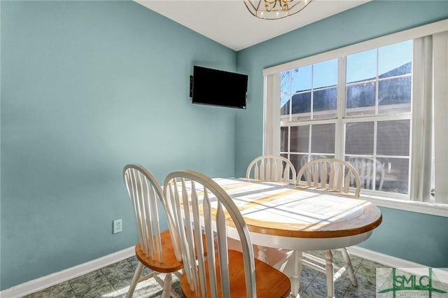 dining room with an inviting chandelier and baseboards