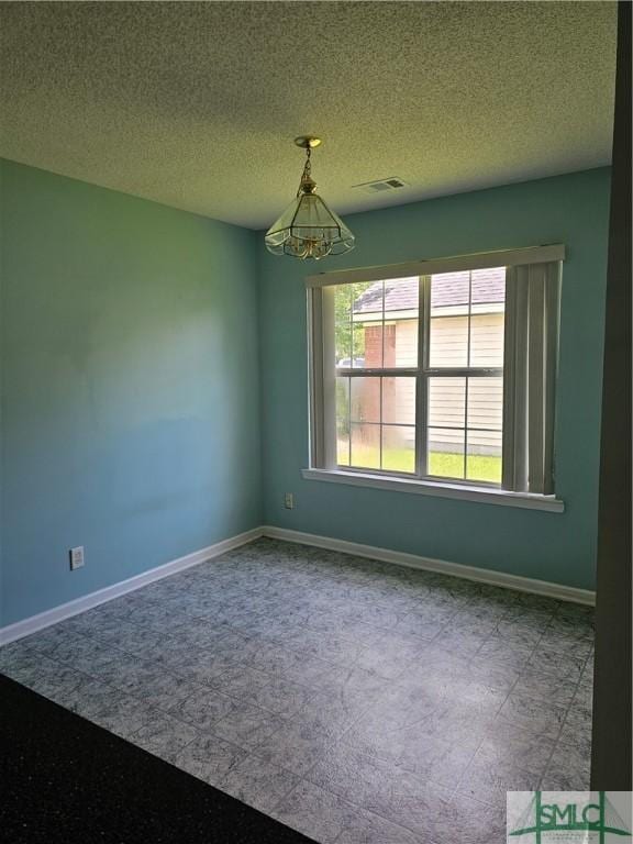 unfurnished room featuring visible vents, a textured ceiling, baseboards, and carpet floors