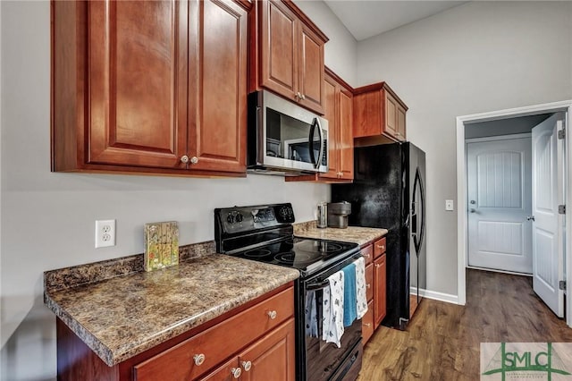 kitchen with baseboards, dark wood-type flooring, black appliances, and brown cabinetry