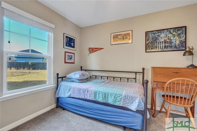 carpeted bedroom featuring baseboards