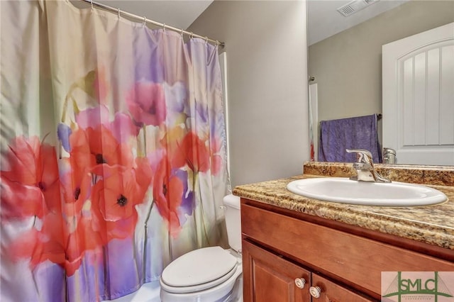 bathroom featuring a shower with shower curtain, visible vents, toilet, and vanity