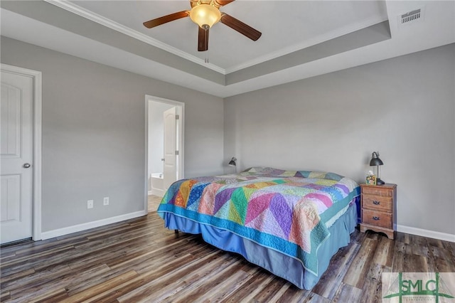 bedroom featuring visible vents, a raised ceiling, baseboards, and wood finished floors