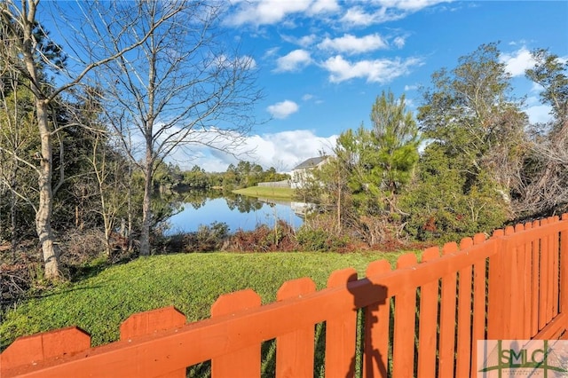 view of yard featuring a water view and fence