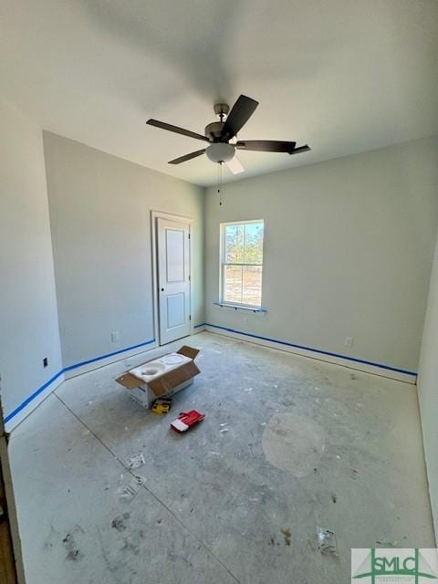 unfurnished room featuring baseboards and ceiling fan