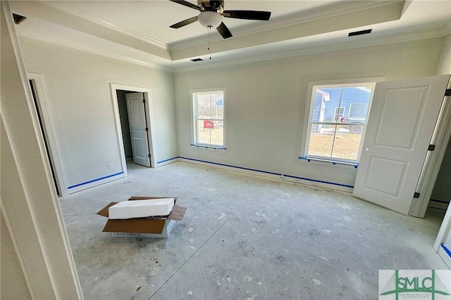 unfurnished bedroom with visible vents, crown molding, and a tray ceiling
