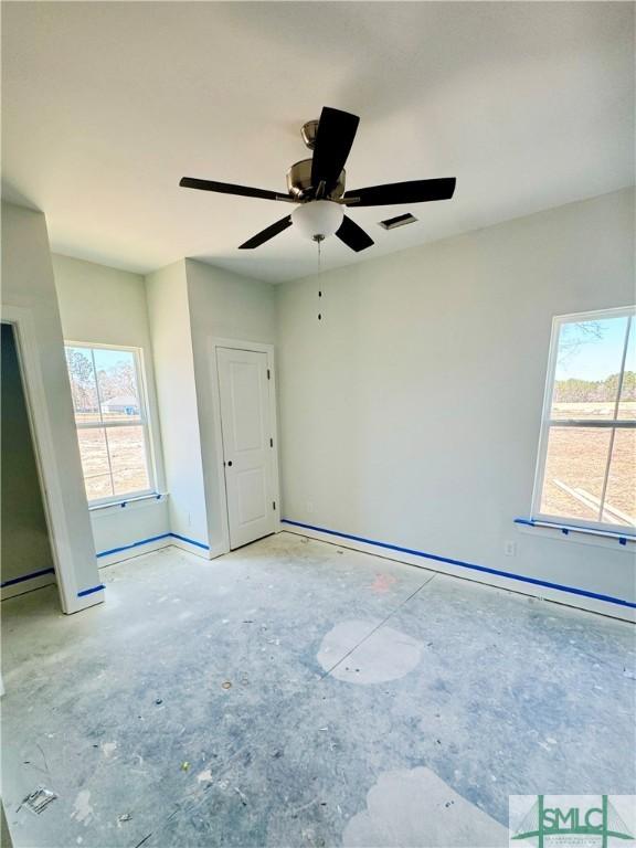 spare room featuring visible vents and a ceiling fan