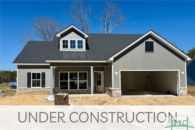 109 Ennis Rd, Pembroke, GA 31321 - view of front facade featuring an attached garage, covered porch, and roof with shingles