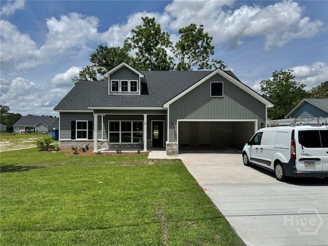 109 Ennis Rd, Pembroke, GA 31321 - view of front of property with a front yard, driveway, a shingled roof, stone siding, and a garage