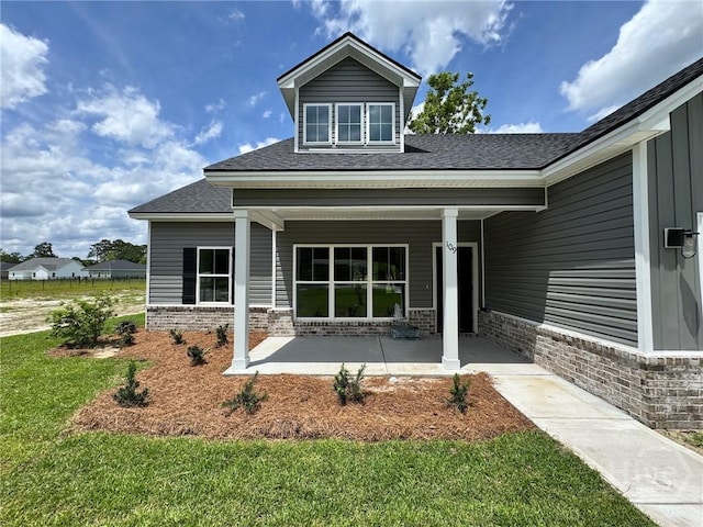 109 Ennis Rd, Pembroke, GA 31321 - entrance to property with a shingled roof, brick siding, and a yard