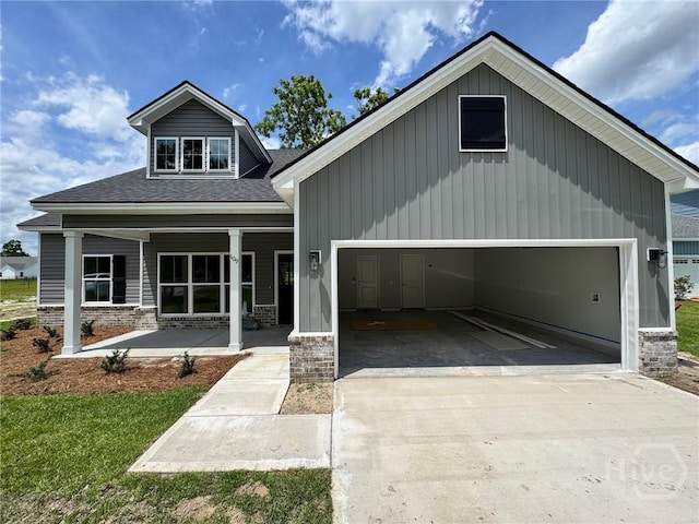 109 Ennis Rd, Pembroke, GA 31321 - view of front of house with driveway, a porch, roof with shingles, and a garage