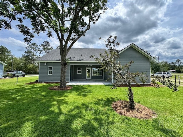 109 Ennis Rd, Pembroke, GA 31321 - rear view of house featuring a patio, a lawn, and a shingled roof