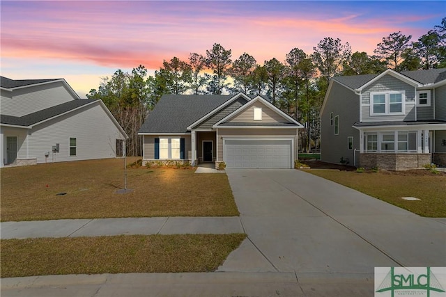 craftsman-style house with a yard, driveway, and a garage