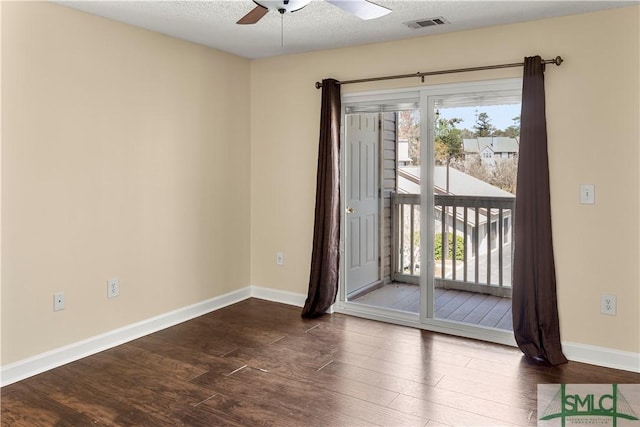 empty room featuring wood finished floors, plenty of natural light, a ceiling fan, and baseboards