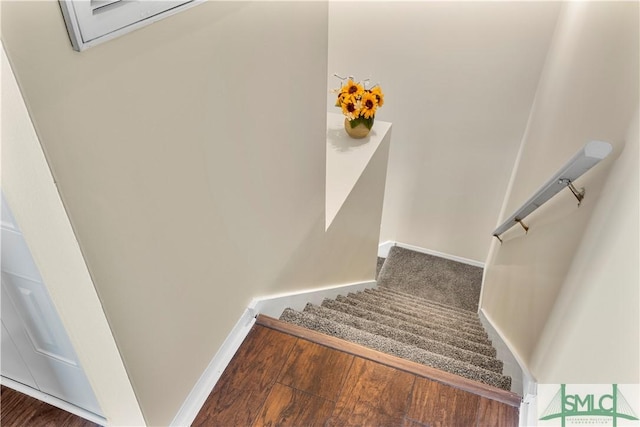 stairs with baseboards and wood finished floors