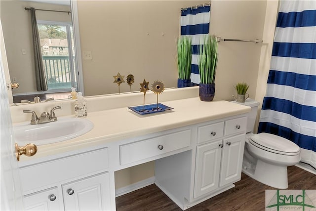 full bathroom with a shower with curtain, toilet, wood finished floors, and vanity